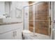 Bathroom featuring a glass enclosed walk-in shower with light-colored tiling at 7595 Sunny Dreams Ln, Kissimmee, FL 34747