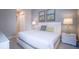 A comfortable bedroom featuring a plush bed with decorative pillows and matching nightstands with lamps at 7595 Sunny Dreams Ln, Kissimmee, FL 34747