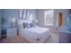 Bright bedroom with white furniture, neutral walls, and natural light from the window at 7595 Sunny Dreams Ln, Kissimmee, FL 34747