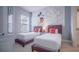 Fun ' bedroom featuring twin beds, colorful artwork, and a whimsical Mickey Mouse themed accent wall at 7595 Sunny Dreams Ln, Kissimmee, FL 34747