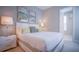 Bright bedroom features stylish decor, plush bedding, and neutral tones, creating a cozy and inviting atmosphere at 7595 Sunny Dreams Ln, Kissimmee, FL 34747