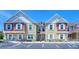 Charming townhouse with colorful siding, white trim, and parking spaces at 7595 Sunny Dreams Ln, Kissimmee, FL 34747