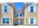 Townhouses with light yellow siding and white trim featuring a charming entrance at 7595 Sunny Dreams Ln, Kissimmee, FL 34747