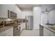 Well-equipped kitchen with stainless appliances, ample cabinet space, and granite counters at 7595 Sunny Dreams Ln, Kissimmee, FL 34747