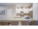 Bright kitchen features granite countertops, stainless steel appliances, and pendant lighting at 7595 Sunny Dreams Ln, Kissimmee, FL 34747