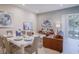 Open-concept living and dining area with modern décor and plenty of natural light at 7595 Sunny Dreams Ln, Kissimmee, FL 34747