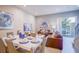 Cozy living and dining room with a neutral color palette and access to outdoor patio at 7595 Sunny Dreams Ln, Kissimmee, FL 34747