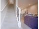 Carpeted staircase leading to the upper floors with views of the open living space at 7595 Sunny Dreams Ln, Kissimmee, FL 34747