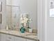 Bathroom featuring double sinks with granite countertops and a decorative orchid plant at 7759 Westland Dr, Kissimmee, FL 34747