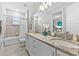 This bathroom features a double sink vanity with granite countertops, a large mirror, and a shower tub at 7759 Westland Dr, Kissimmee, FL 34747