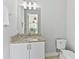 Bright bathroom with granite countertop, modern fixtures and a view from the mirror of the backyard at 7759 Westland Dr, Kissimmee, FL 34747