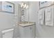 The bathroom features a single sink vanity with granite countertop, a wall mirror, and towel rack at 7759 Westland Dr, Kissimmee, FL 34747
