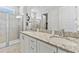Elegant bathroom featuring double sinks, granite countertops, and a glass-enclosed shower at 7759 Westland Dr, Kissimmee, FL 34747