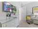 This bedroom features a dresser, a TV, and an adjacent chair for relaxing and watching entertainment at 7759 Westland Dr, Kissimmee, FL 34747