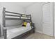 This bedroom has a bunk bed with white bedding, a closet for storage and modern, neutral decor at 7759 Westland Dr, Kissimmee, FL 34747