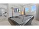 This game room features a pool table, wall-mounted TV, modern lighting, and fun 'Billiards' wall decor at 7759 Westland Dr, Kissimmee, FL 34747