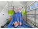 Garage game room featuring an electronic basketball game, sports-themed decor, and ample space for activities at 7759 Westland Dr, Kissimmee, FL 34747
