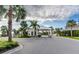 Gated community entrance with lush landscaping, palm trees, and a secure entryway at 7759 Westland Dr, Kissimmee, FL 34747