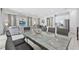 Open-concept living area with a dining table, living room, kitchen, tile floor, and neutral color palette at 7759 Westland Dr, Kissimmee, FL 34747