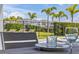 Stylish outdoor table setting beside the pool offers a perfect spot for al fresco dining at 7759 Westland Dr, Kissimmee, FL 34747