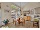 Cozy breakfast nook with large windows, and a charming hutch with decorative plates and vintage furniture at 796 Mcintyre Ave, Winter Park, FL 32789