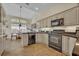 Well-lit kitchen featuring neutral cabinetry, granite countertops, and modern appliances with tile floor at 796 Mcintyre Ave, Winter Park, FL 32789