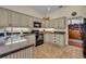 Modern kitchen features neutral cabinetry, granite countertops, and modern appliances with tile floor at 796 Mcintyre Ave, Winter Park, FL 32789