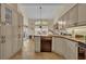 Spacious kitchen features neutral cabinetry, granite countertops, and modern appliances with tile floor at 796 Mcintyre Ave, Winter Park, FL 32789