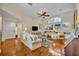 Bright and airy living room featuring hardwood floors, ceiling fan, and large windows at 796 Mcintyre Ave, Winter Park, FL 32789