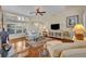 Comfortable living room featuring gleaming hardwood floors and a cozy seating arrangement at 796 Mcintyre Ave, Winter Park, FL 32789