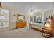 Bright main bedroom with large window, ceiling fan, and an ensuite bathroom at 796 Mcintyre Ave, Winter Park, FL 32789