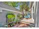 Charming courtyard patio featuring brick, plants, and seating area with mature landscaping and privacy wall at 796 Mcintyre Ave, Winter Park, FL 32789