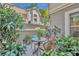 Charming courtyard patio featuring pavers, plants, and seating area with mature landscaping and privacy wall at 796 Mcintyre Ave, Winter Park, FL 32789