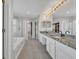 Bathroom features double sink vanity with granite countertop, soaking tub, and glass shower at 821 Veranda Pl, Celebration, FL 34747