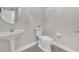 This bathroom offers a pedestal sink, oval mirror, and tile flooring at 821 Veranda Pl, Celebration, FL 34747