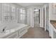 Bathroom featuring a soaking tub, glass shower, and tile floors at 821 Veranda Pl, Celebration, FL 34747