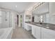 Bathroom features double sink vanity with granite countertop, soaking tub, and glass shower at 821 Veranda Pl, Celebration, FL 34747