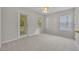 Bright bedroom boasts neutral carpet, a ceiling fan, and a glass door to outside at 821 Veranda Pl, Celebration, FL 34747