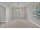 Formal dining room with a modern chandelier, neutral walls, and bright windows at 821 Veranda Pl, Celebration, FL 34747