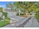 View of the driveway that leads to the 2-car garage, with well maintained landscaping at 821 Veranda Pl, Celebration, FL 34747