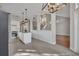 The kitchen features an island and stainless appliances adjacent to a staircase at 821 Veranda Pl, Celebration, FL 34747