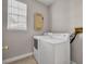 Practical laundry area featuring a washer, dryer, and window for natural light at 821 Veranda Pl, Celebration, FL 34747