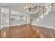 Spacious living room showcasing hardwood floors, staircase, and open access to the kitchen at 821 Veranda Pl, Celebration, FL 34747
