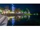 Reflective night view of the town center's tower and lights along the waterfront at 821 Veranda Pl, Celebration, FL 34747