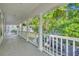Lovely porch with white columns, railings, and views of tree-lined neighborhood at 821 Veranda Pl, Celebration, FL 34747