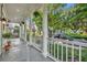 Spacious porch view showing white railing, stately columns and a glimpse of a tree-lined street at 821 Veranda Pl, Celebration, FL 34747