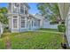Beautiful home exterior with lush green lawn and charming architectural details at 821 Veranda Pl, Celebration, FL 34747