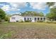 The home features a large backyard and sunroom, with mature landscaping at 8506 Shady Glen Dr, Orlando, FL 32819