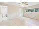 Spacious bedroom with bathroom, tile floors, and a large window at 8506 Shady Glen Dr, Orlando, FL 32819