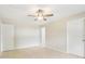 A bright bedroom features neutral walls, tile flooring, and a ceiling fan for added comfort at 8506 Shady Glen Dr, Orlando, FL 32819